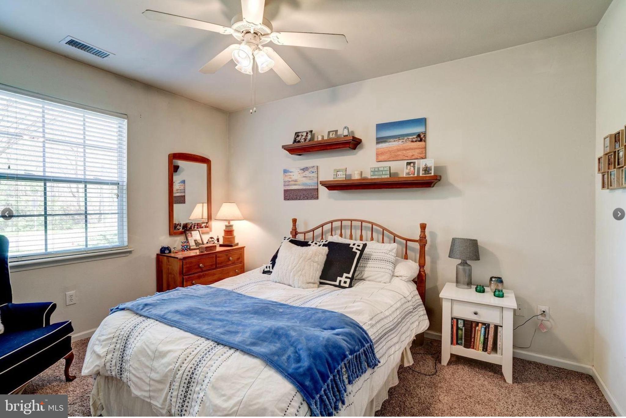 12957 Centre Park Circle, Unit 112 Herndon, VA 20171 - Photo 13 of 25 a bedroom with a bed and wooden floor