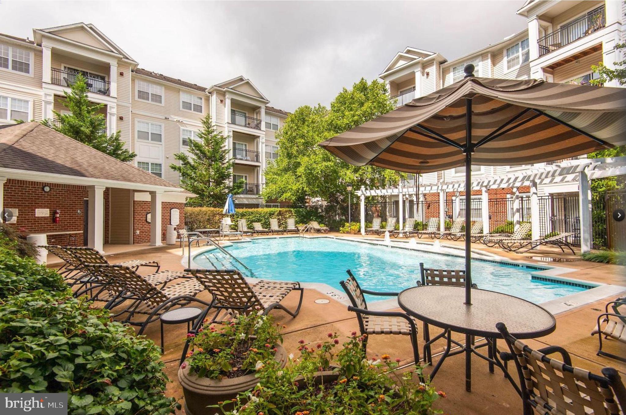12957 Centre Park Circle, Unit 112 Herndon, VA 20171 - Photo 15 of 25 a view of a swimming pool with a patio