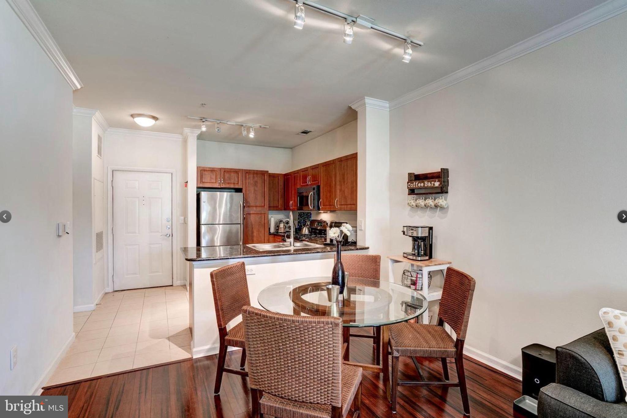 12957 Centre Park Circle, Unit 112 Herndon, VA 20171 - Photo 6 of 25 a view of a dining room with furniture and a potted plant