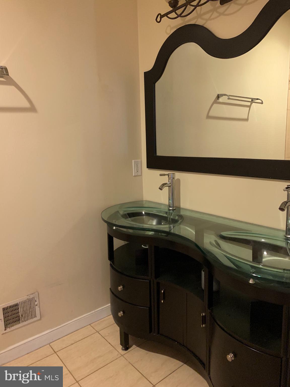 2237 14th Street Southeast Washington, DC 20020 - Photo 21 of 32 a bathroom with a sink and a mirror
