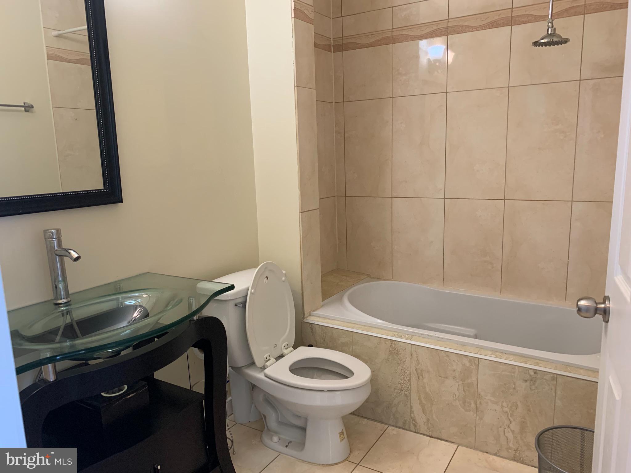 2237 14th Street Southeast Washington, DC 20020 - Photo 26 of 32 a bathroom with a sink a toilet and a bathtub