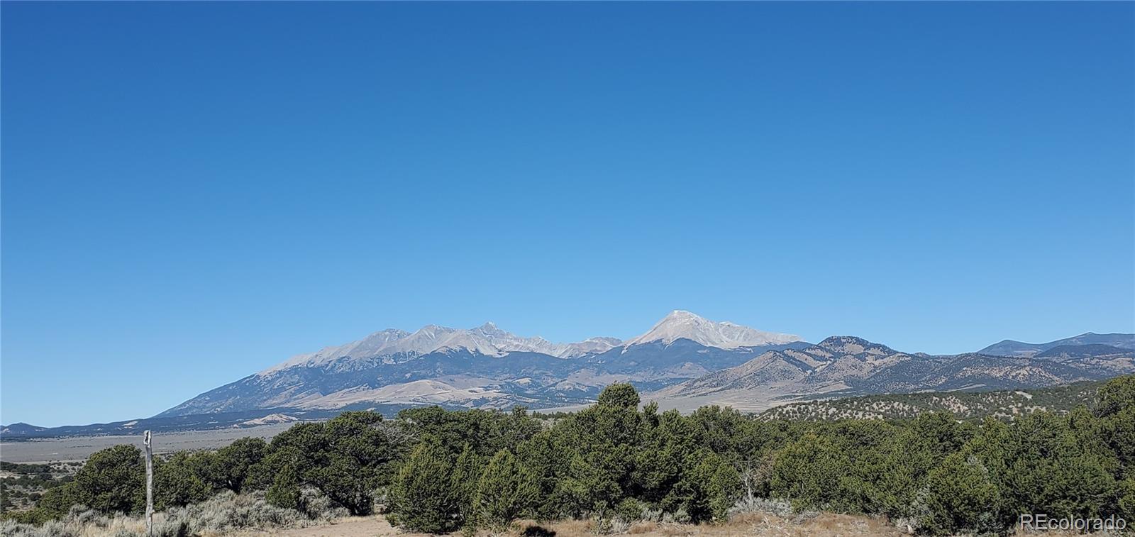 Lot 7356 Bidwell Road Fort Garland, CO 81133 - Photo 18 of 23 a view of a lush green hillside and a houses