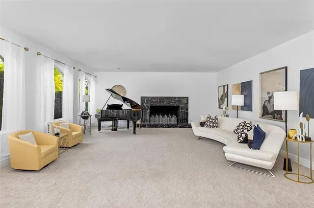 a kitchen with granite countertop white cabinets white appliances a sink and a window