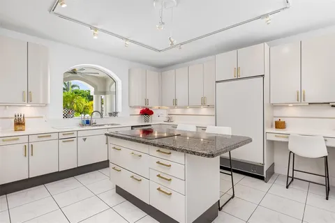 a kitchen with stainless steel appliances granite countertop a sink a counter space and cabinets