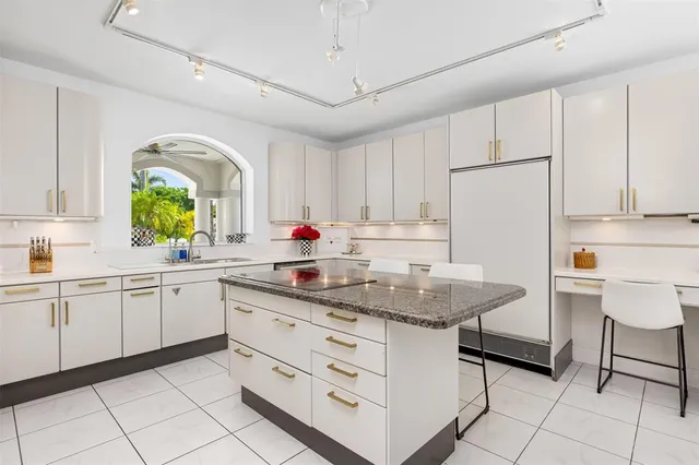 a kitchen with stainless steel appliances granite countertop a sink a counter space and cabinets