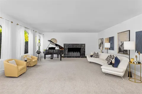 a dining room with furniture a window and a chandelier