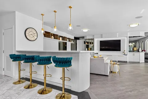 a living room with furniture and a clock