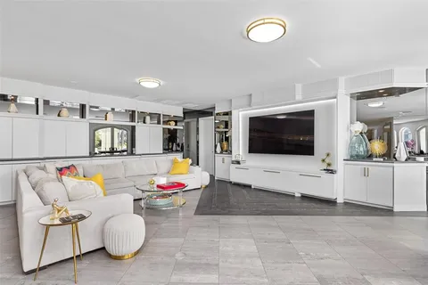 a spacious bedroom with a bed dresser and a couch