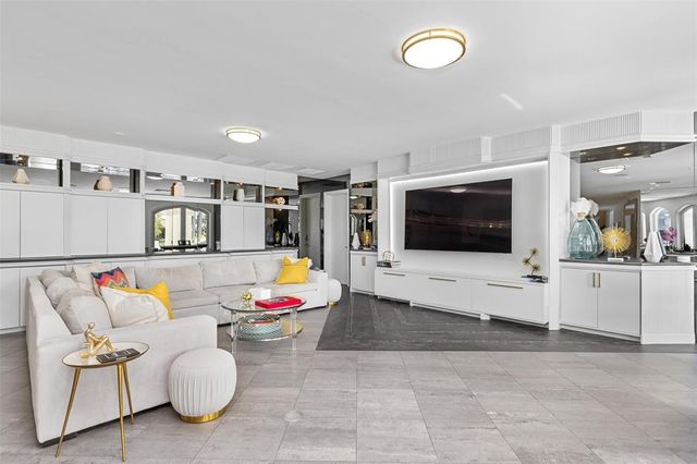 a spacious bedroom with a bed dresser and a couch