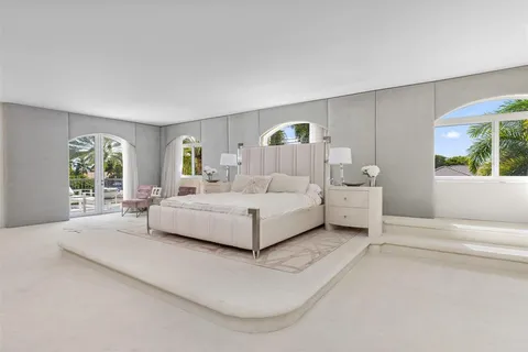 a spacious bedroom with a bed and a couch