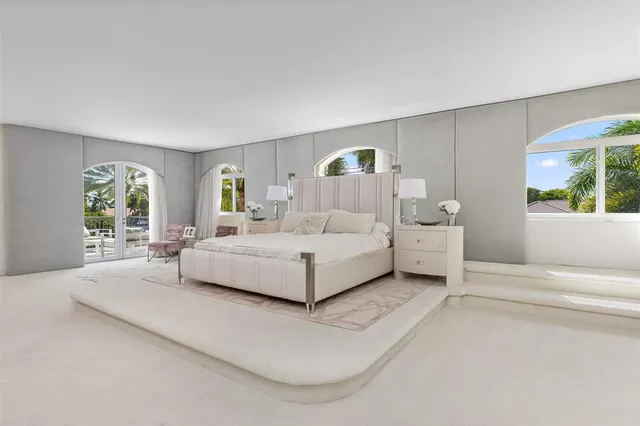 a spacious bedroom with a bed and a couch