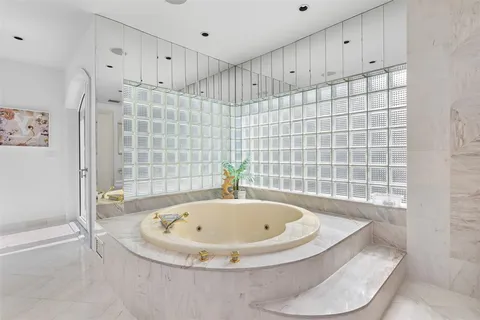 a spacious bathroom with double vanity and a mirror