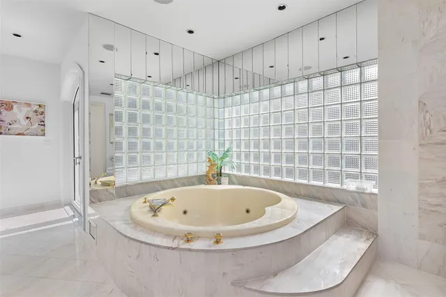 a spacious bathroom with double vanity and a mirror