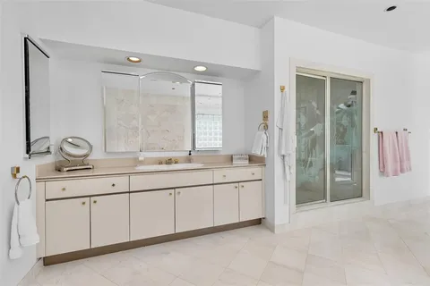 a bathroom with double sink and a mirror