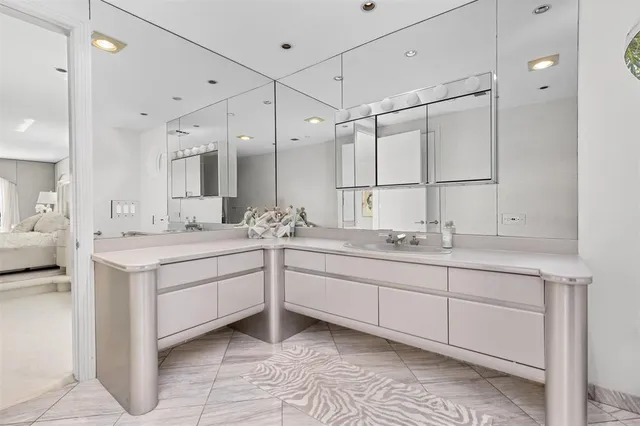 a spacious bedroom with a bed and a flat screen tv