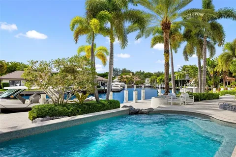 a view of a house with a swimming pool and sitting area