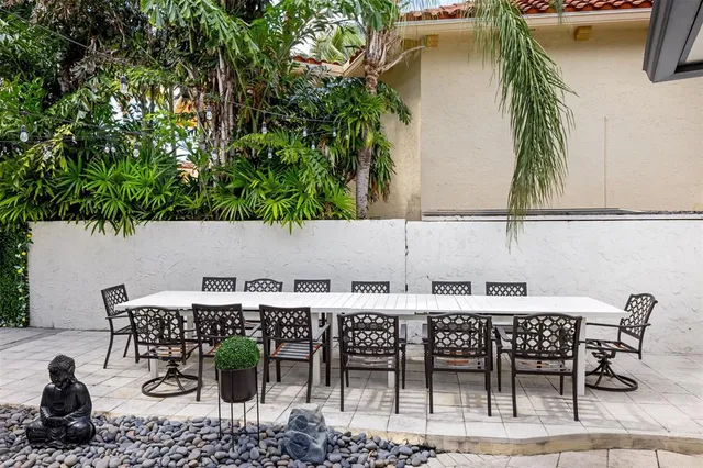 a view of a patio with table and chairs and potted plants