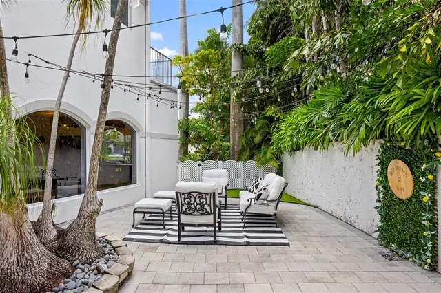 an aerial view of residential houses with outdoor space and lake view