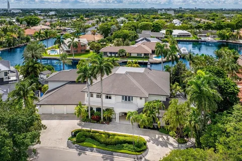 an aerial view of residential houses with outdoor space and lake view