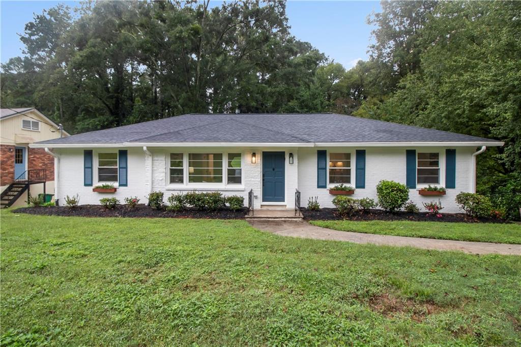 607 Densley Drive Decatur, GA 30033 - Photo 1 of 1 a front view of a house with a garden and porch