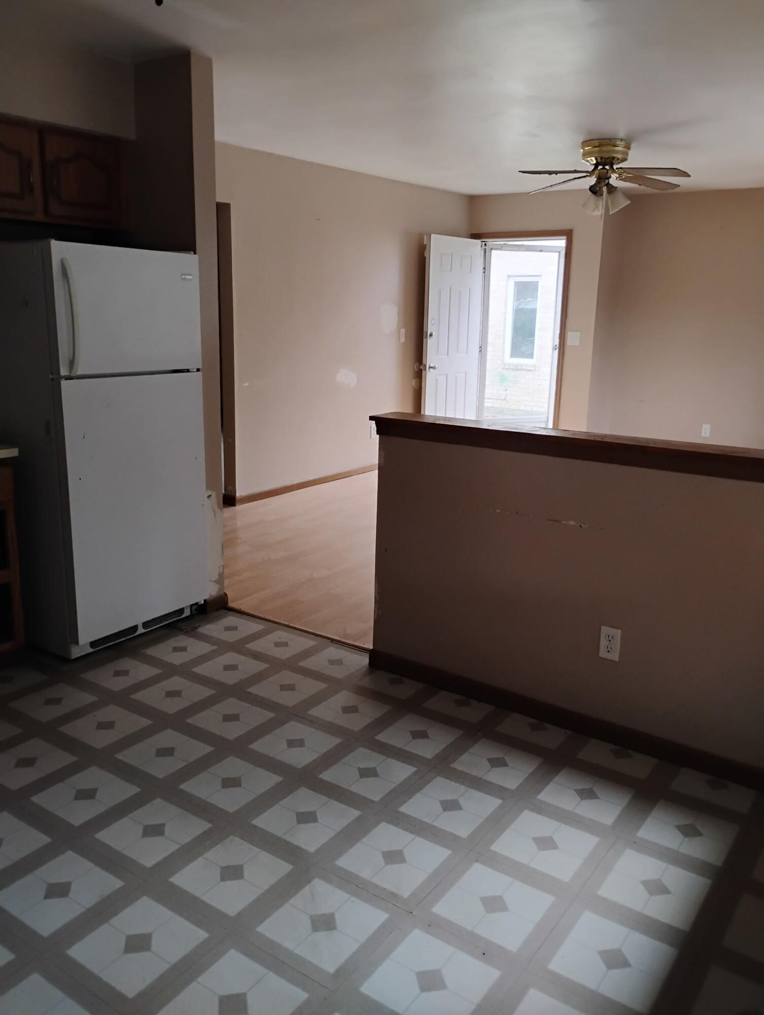 144 Meadow Road Crown Point, IN 46307 - Photo 5 of 10 a view of a refrigerator in kitchen and an empty room