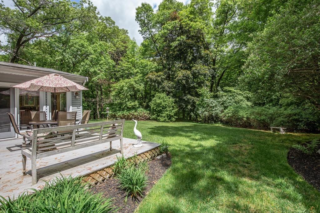 119 Killam Hill Road Boxford, MA 01921 - Photo 6 of 21 a view of a patio with table and chairs under an umbrella