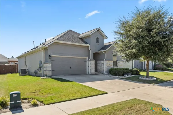 a front view of a house with a yard