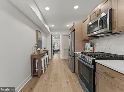 a kitchen with stainless steel appliances granite countertop a stove and a refrigerator