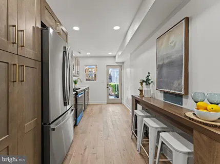 a kitchen with stainless steel appliances granite countertop a refrigerator and a sink