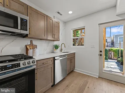a kitchen with stainless steel appliances a stove a microwave and cabinets