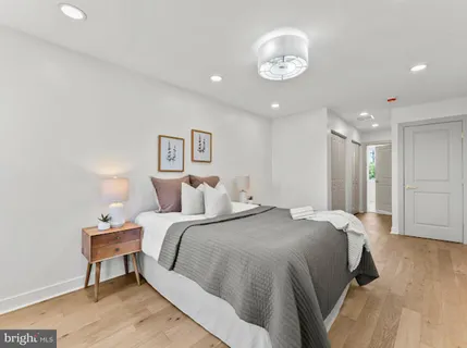 a spacious bedroom with a bed and a chandelier
