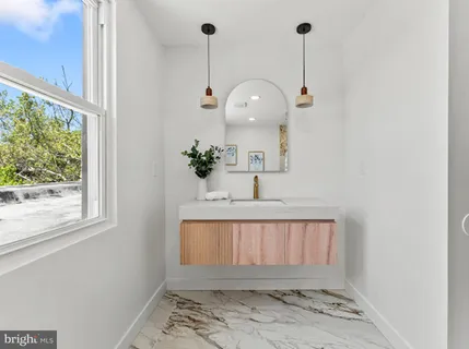 a bathroom with a sink a mirror and window