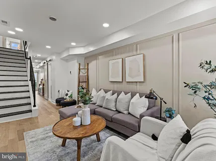 a living room with furniture and a potted plant
