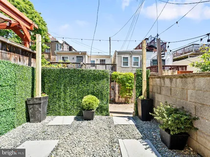 a view of a street with potted plants