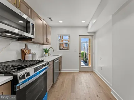 a kitchen with stainless steel appliances granite countertop a stove and a refrigerator