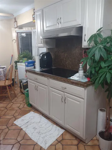 a view of a fire pit in a yard with potted plants