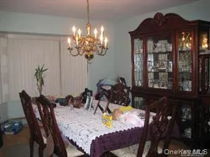 a view of a dining room with furniture and chandelier