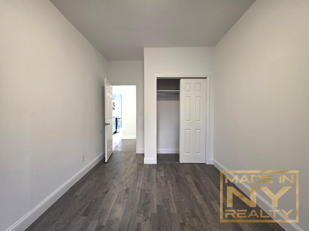117-14 Union Turnpike, Unit EB2 Queens, NY 11415 - Photo 10 of 10 a view of a hallway with wooden floor