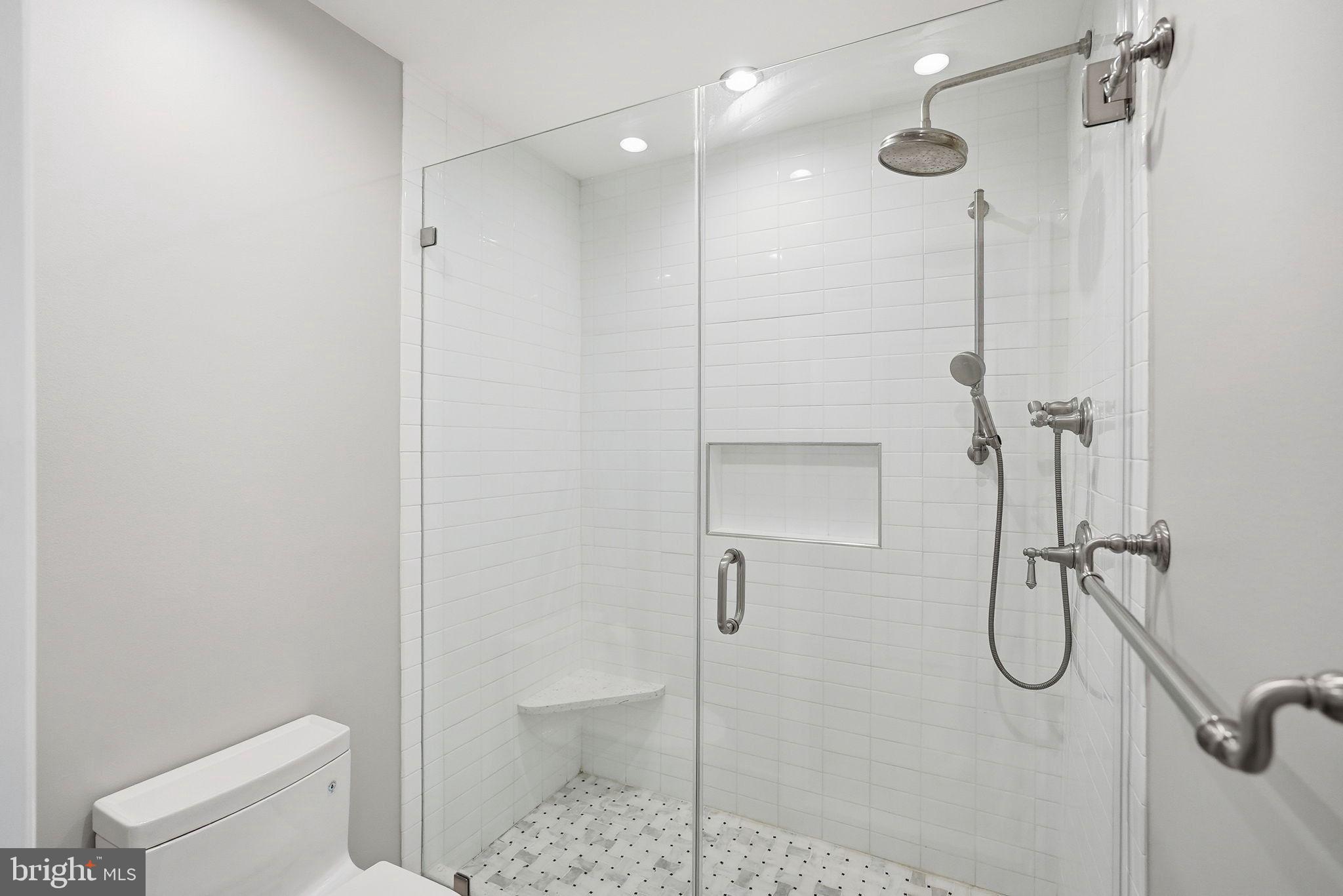 1140 23rd Street Northwest, Unit 1005 Washington, DC 20037 - Photo 11 of 22 a bathroom with a glass shower door