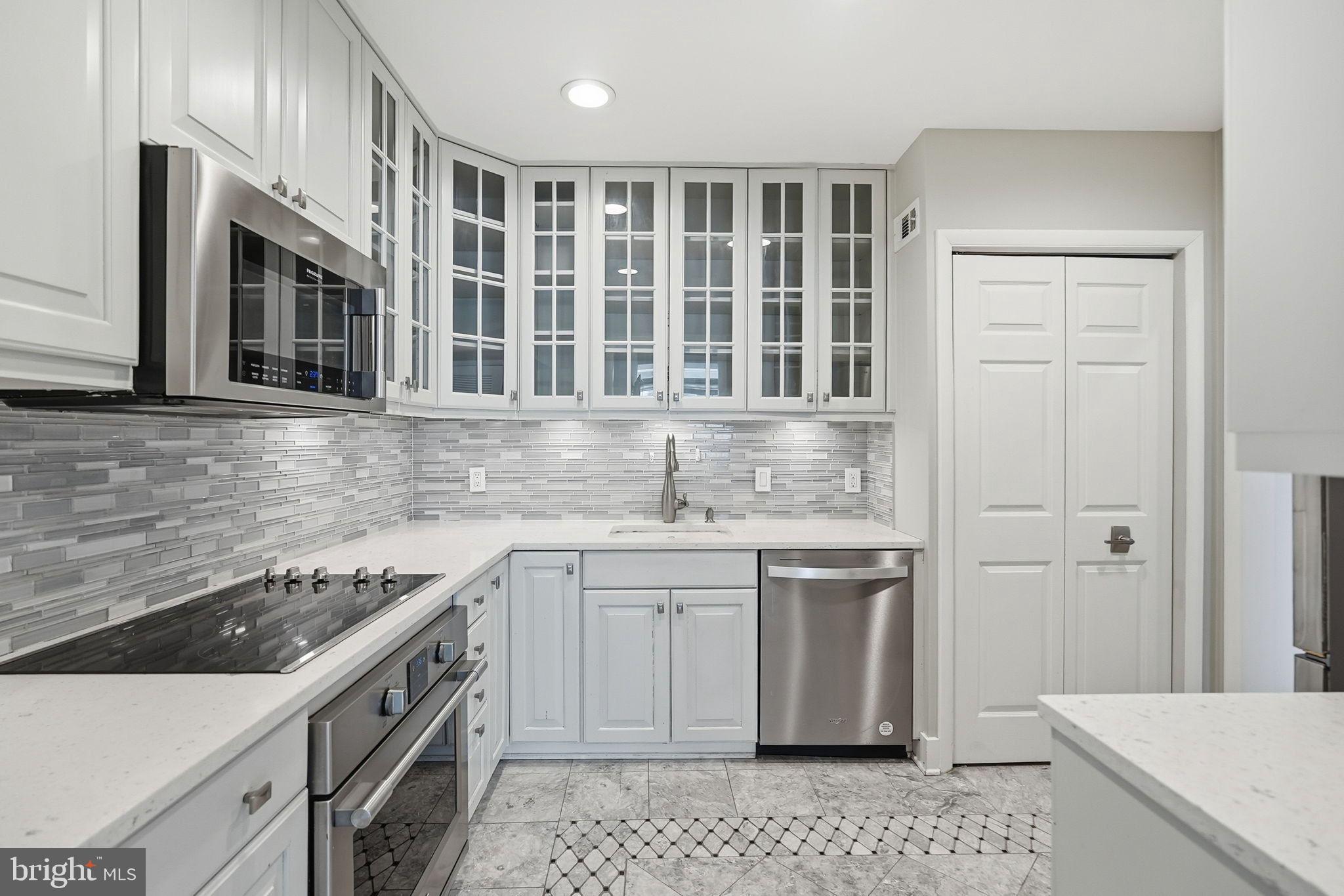 1140 23rd Street Northwest, Unit 1005 Washington, DC 20037 - Photo 3 of 22 a kitchen with a sink stove and cabinets