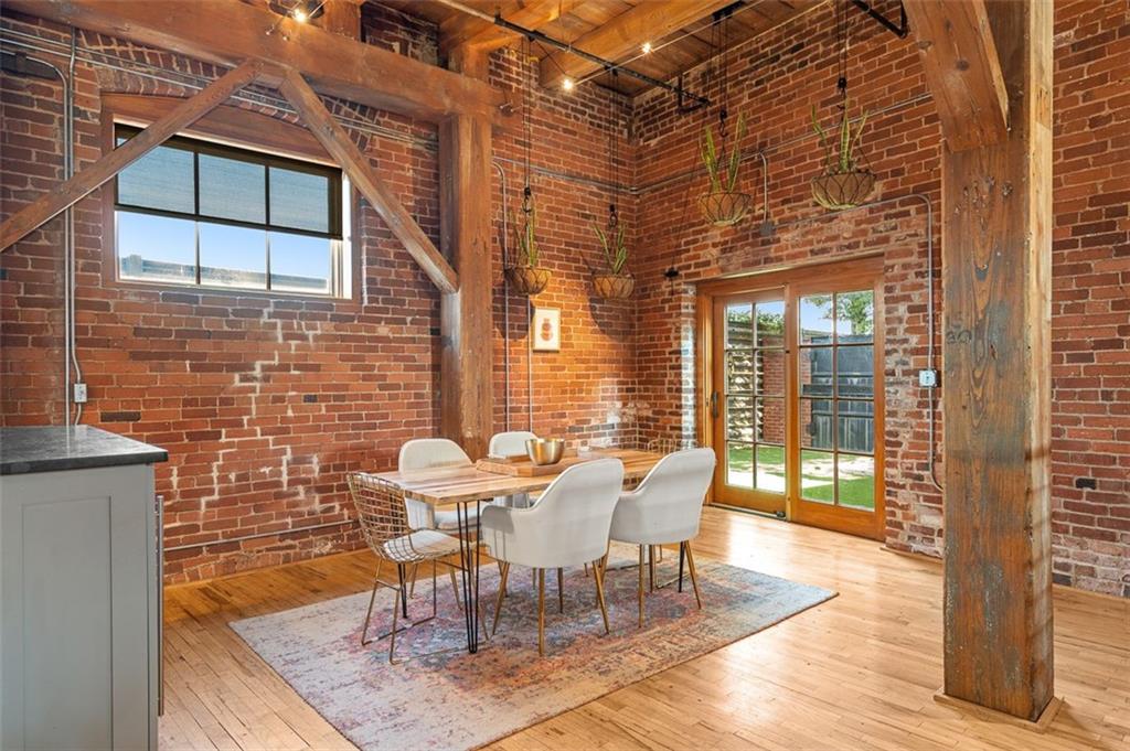 490 Marietta Street Northwest, Unit 101 Atlanta, GA 30313 - Photo 19 of 102 a view of a patio with table and chairs with wooden floor and fence