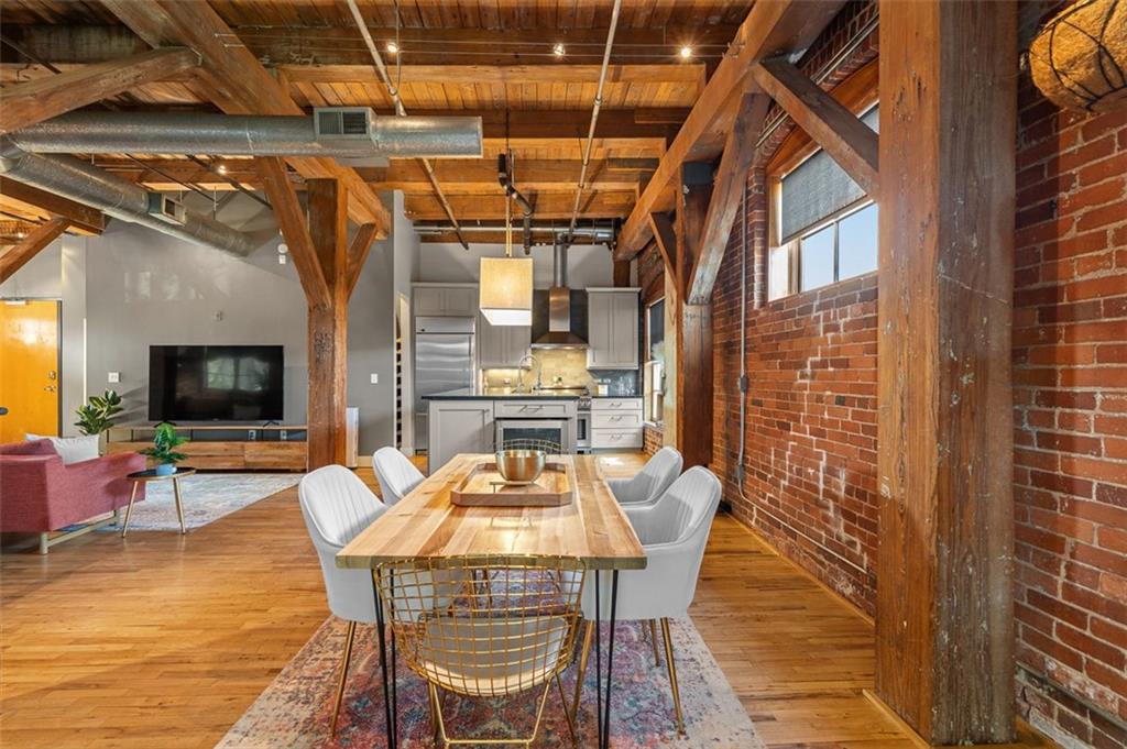 490 Marietta Street Northwest, Unit 101 Atlanta, GA 30313 - Photo 22 of 102 a view of a dining room with furniture a chandelier and wooden floor