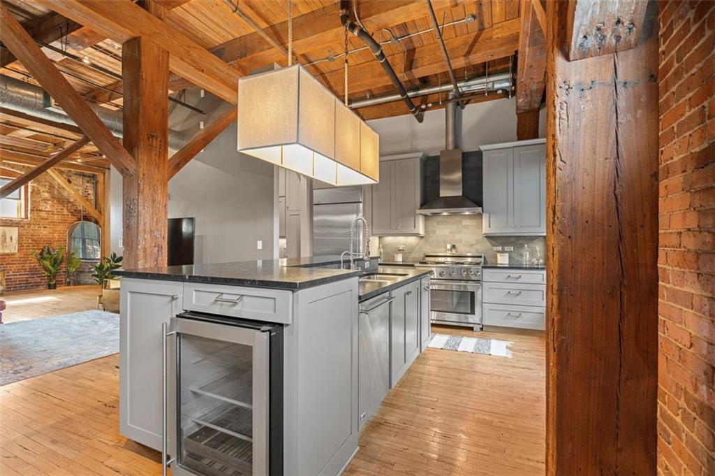 490 Marietta Street Northwest, Unit 101 Atlanta, GA 30313 - Photo 25 of 102 a kitchen with stainless steel appliances granite countertop a stove and cabinets