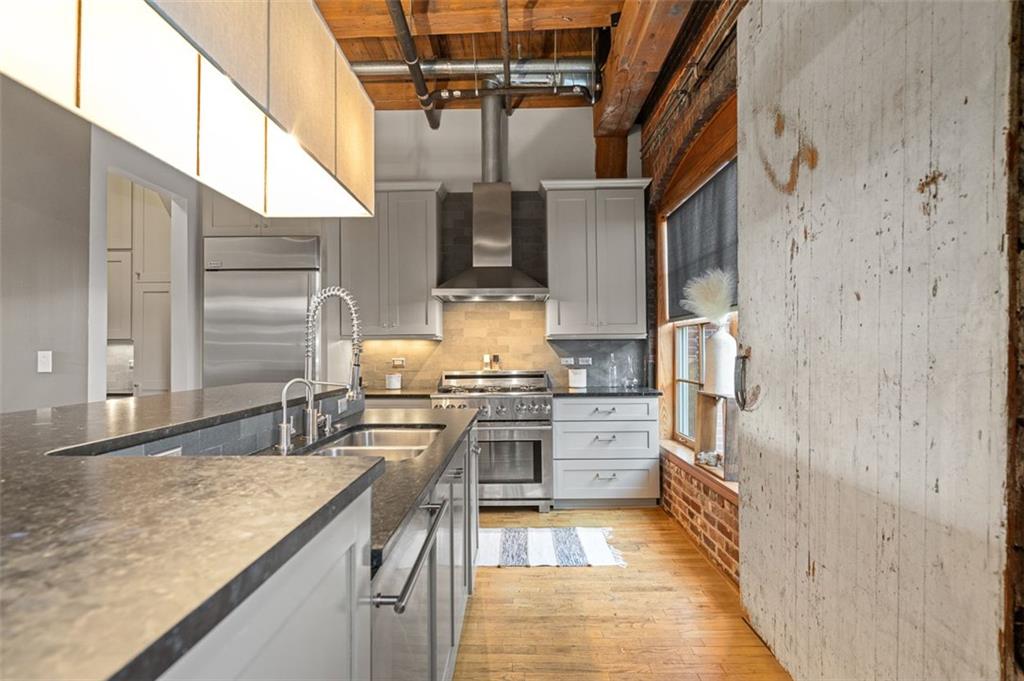 490 Marietta Street Northwest, Unit 101 Atlanta, GA 30313 - Photo 26 of 102 a kitchen with stainless steel appliances granite countertop a sink and cabinets
