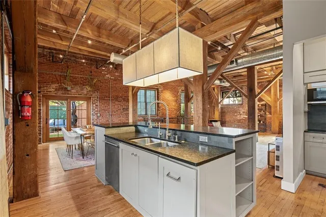 a backyard of a house with barbeque oven table and chairs