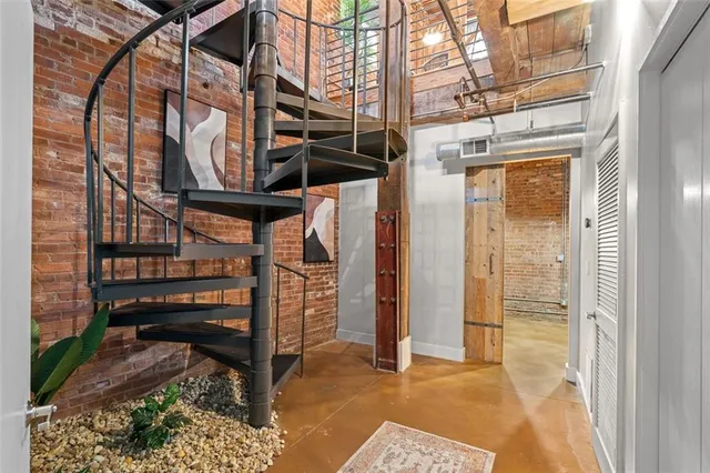 a backyard of a house with barbeque oven table and chairs