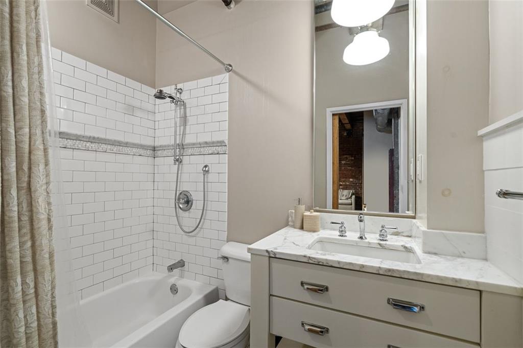 490 Marietta Street Northwest, Unit 101 Atlanta, GA 30313 - Photo 40 of 102 a bathroom with a granite countertop sink a toilet and shower