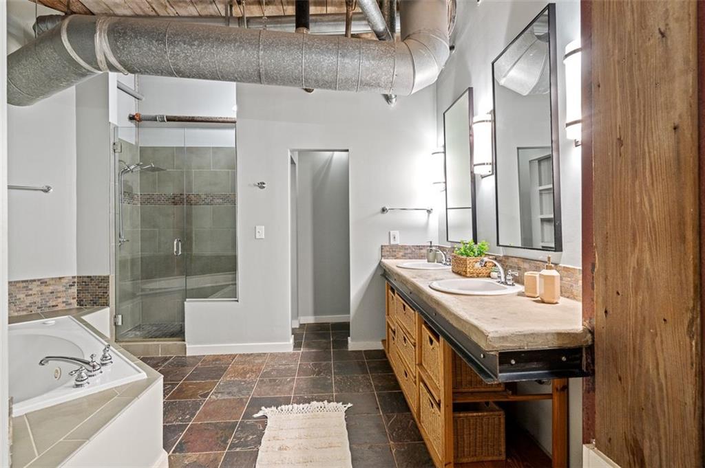 490 Marietta Street Northwest, Unit 101 Atlanta, GA 30313 - Photo 46 of 102 a bathroom with a sink a mirror and a bathtub