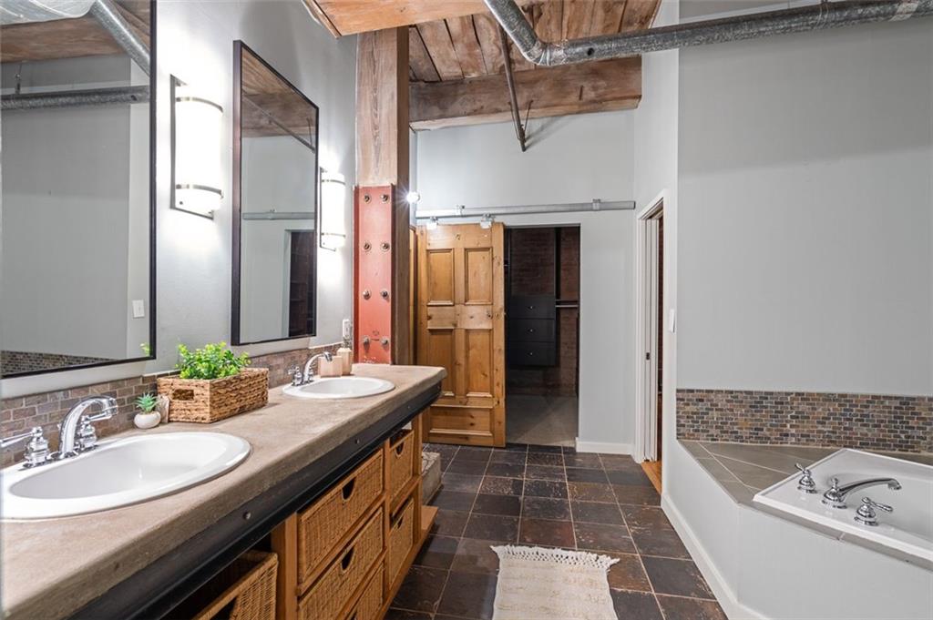 490 Marietta Street Northwest, Unit 101 Atlanta, GA 30313 - Photo 50 of 102 a bathroom with a double vanity sink and a mirror