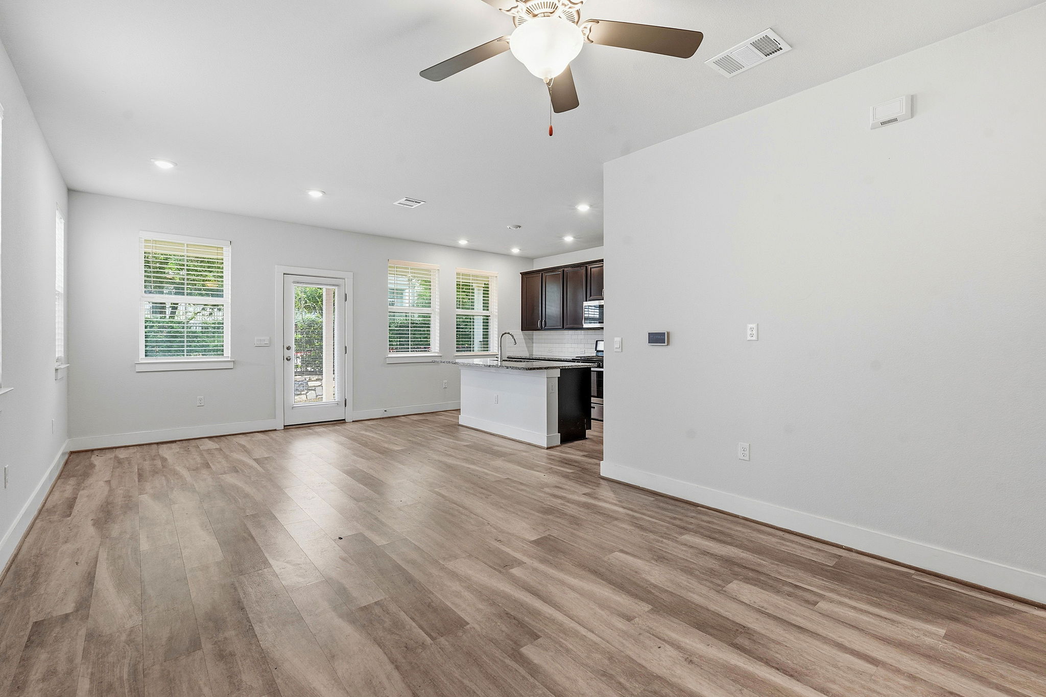 7105 Silver Star Lane, Unit 59 Austin, TX 78744 - Photo 19 of 19 wooden floor in an empty room with a window